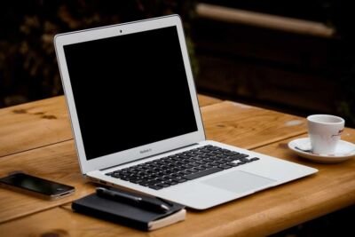 Laptop and coffee on a wooden desk
