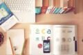 Desk with notebook, phone and office supplies
