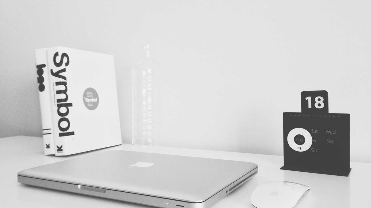 Laptop with a product box on a white desk